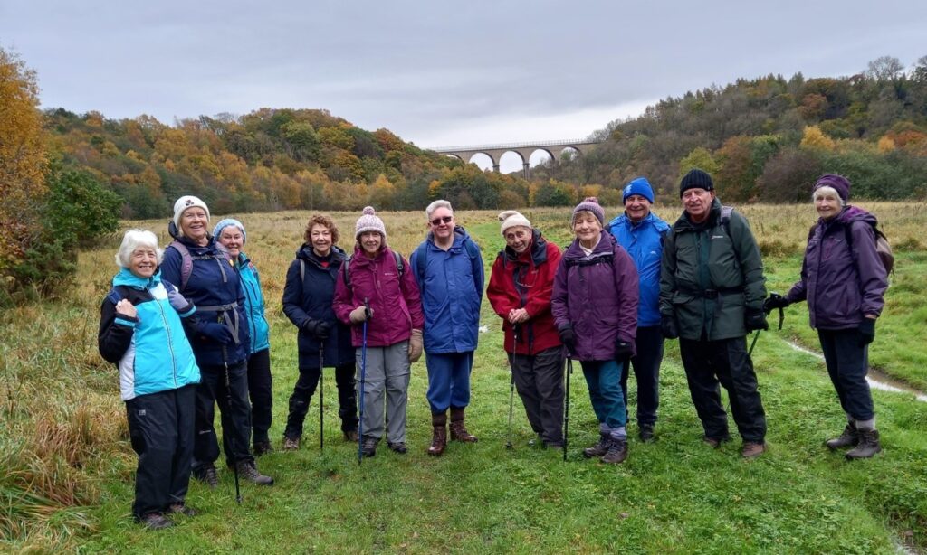 group of 11 walkers with view of viaduct behind them