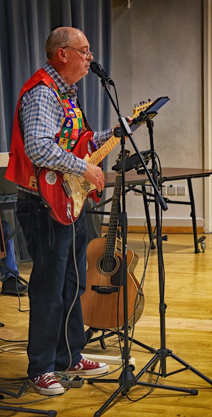 Gerald playing guitar and singing
